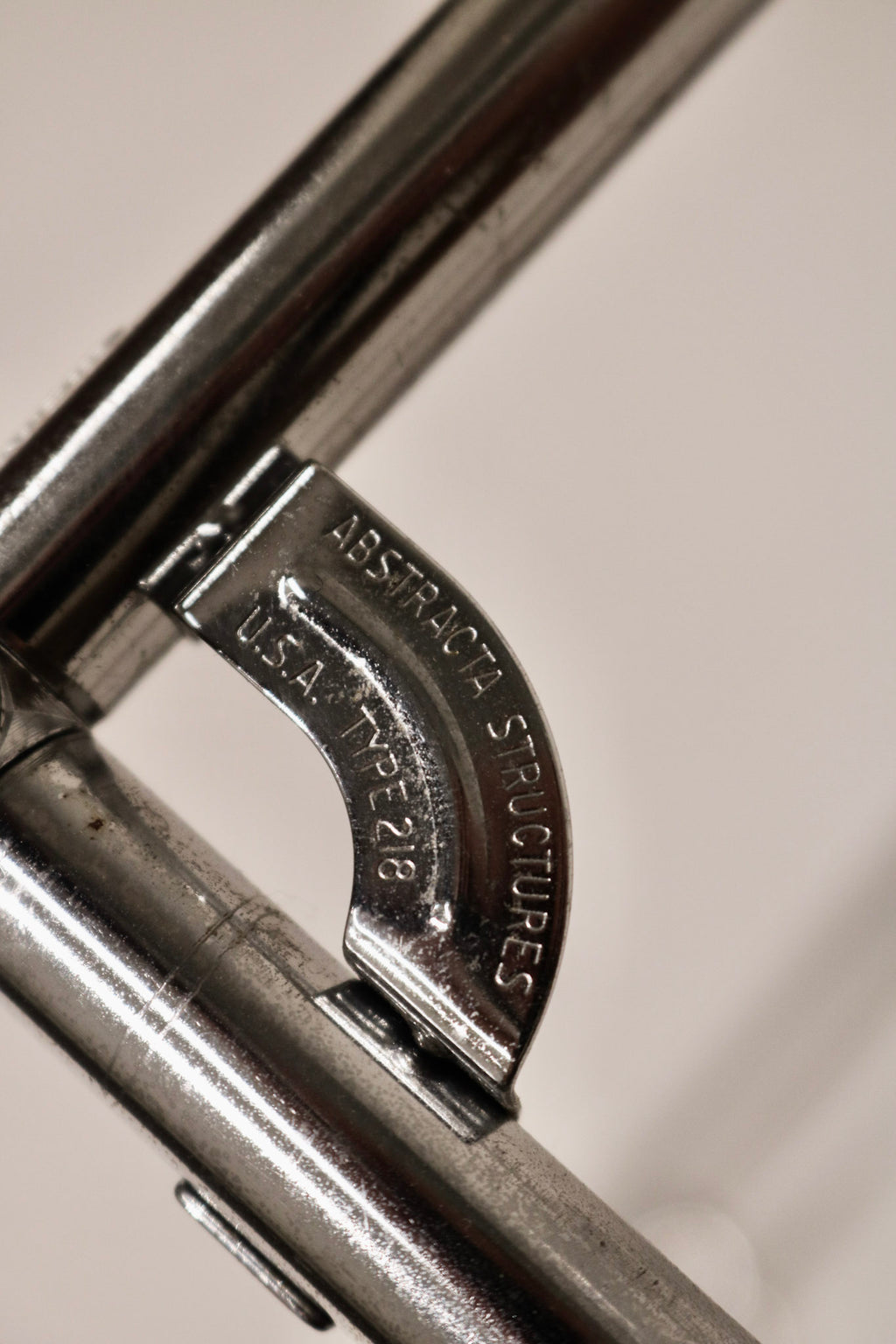 Close-up of the signature Abstracta metal connector joint mechanism and branding