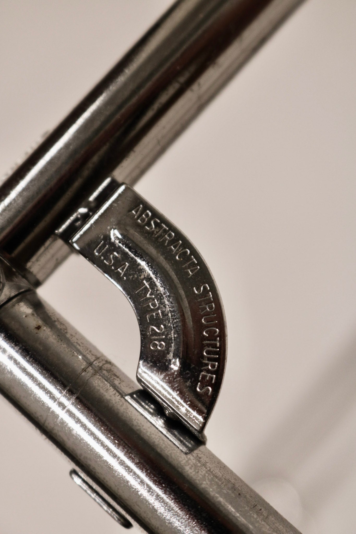 Close-up of the signature Abstracta metal connector joint mechanism and branding