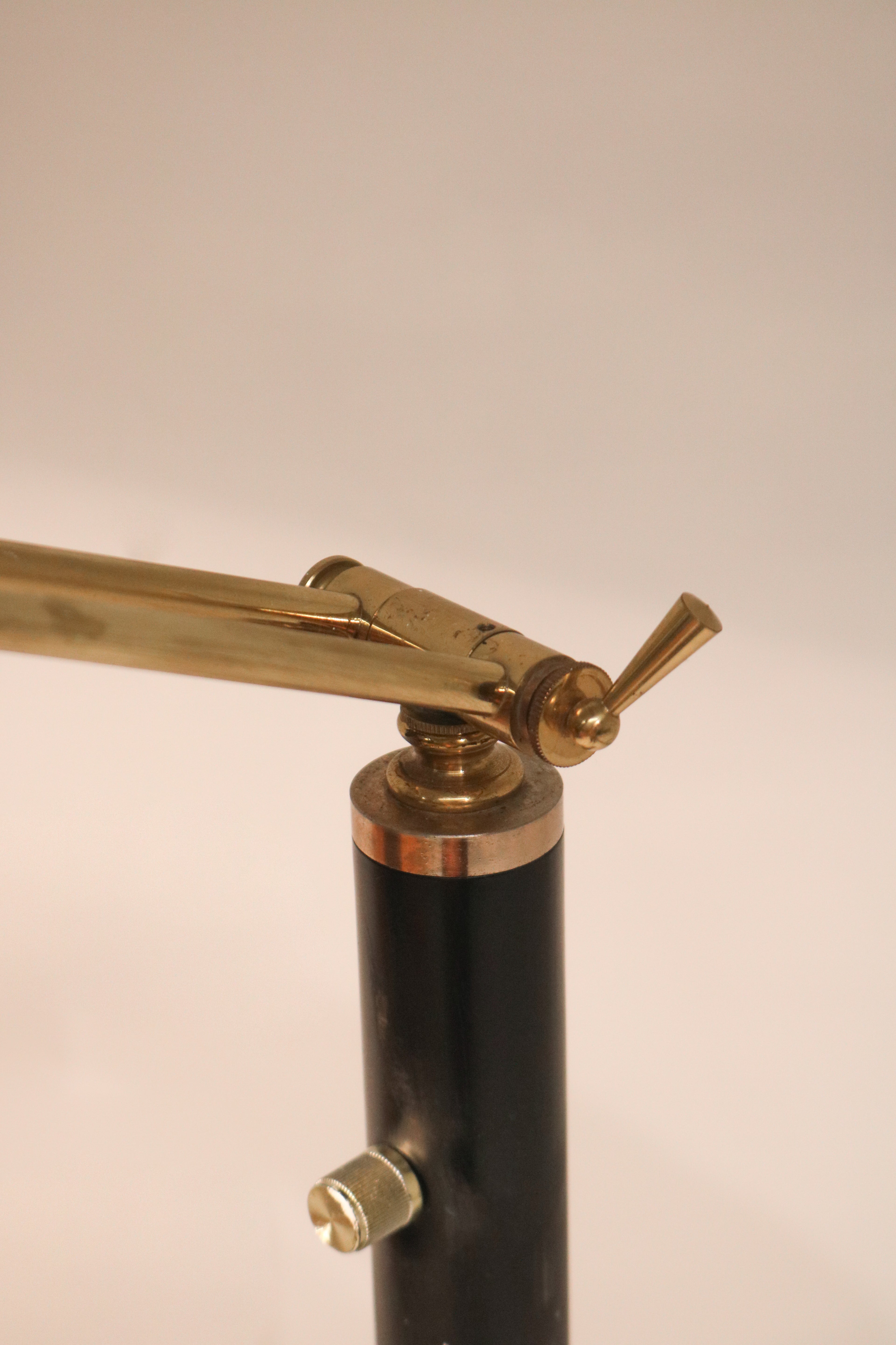 Close-up of the adjustable brass arm mechanism and pivot