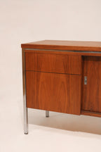 Angled left view emphasizing the chrome frame and walnut contrast