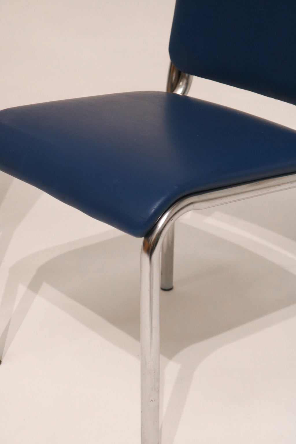 Angled top view showing the blue leather seats and chrome frame