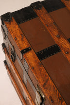 Angled top view of closed trunk lid showing wood finish and iron straps