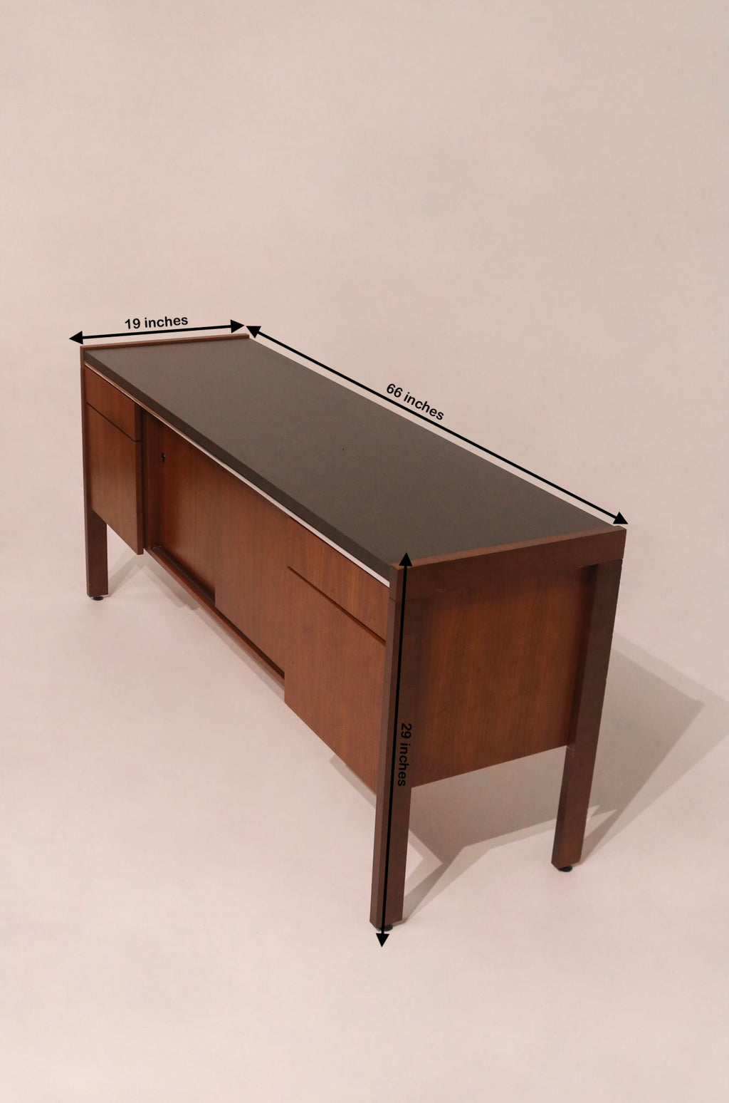 Angled top view showing the black laminate top and walnut body contrast