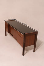 Angled top view showing the black laminate top and walnut body contrast