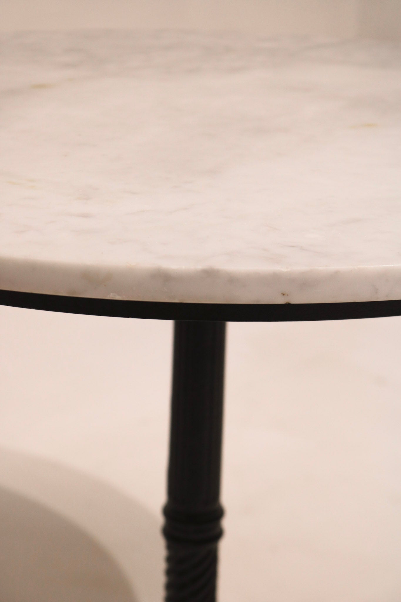 Angled top view showing white marble veining and round shape