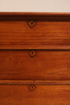 Macro detail of antique keyhole lock embedded in cherry pine wood
