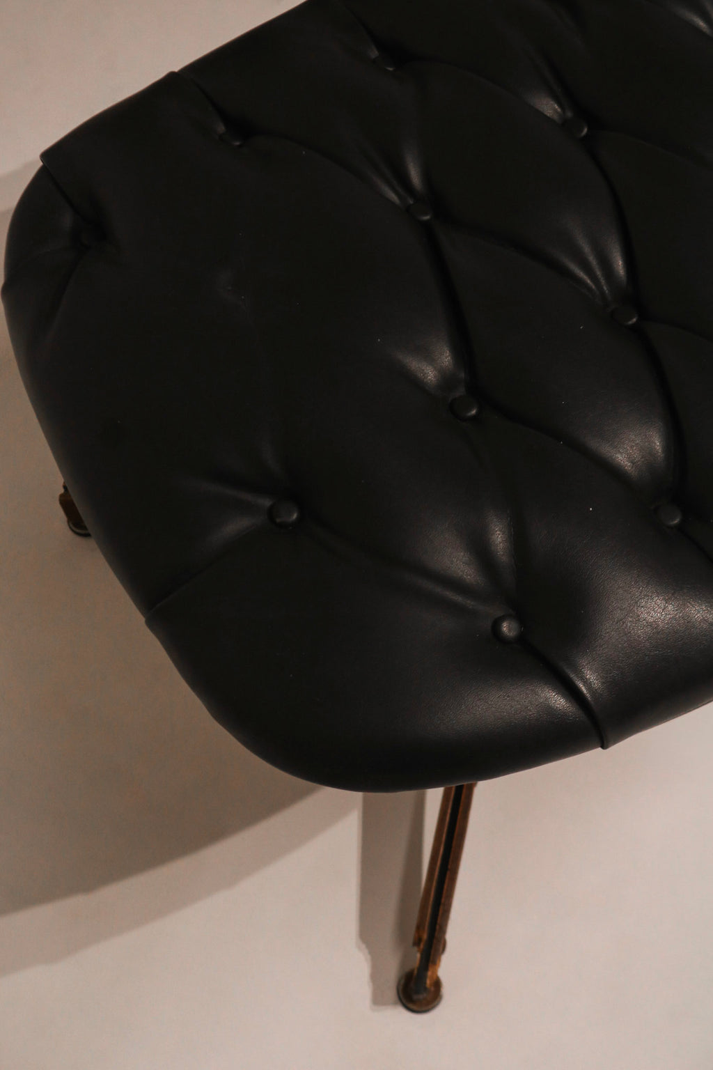 Detail of the armrest side panel showing wood texture and curve