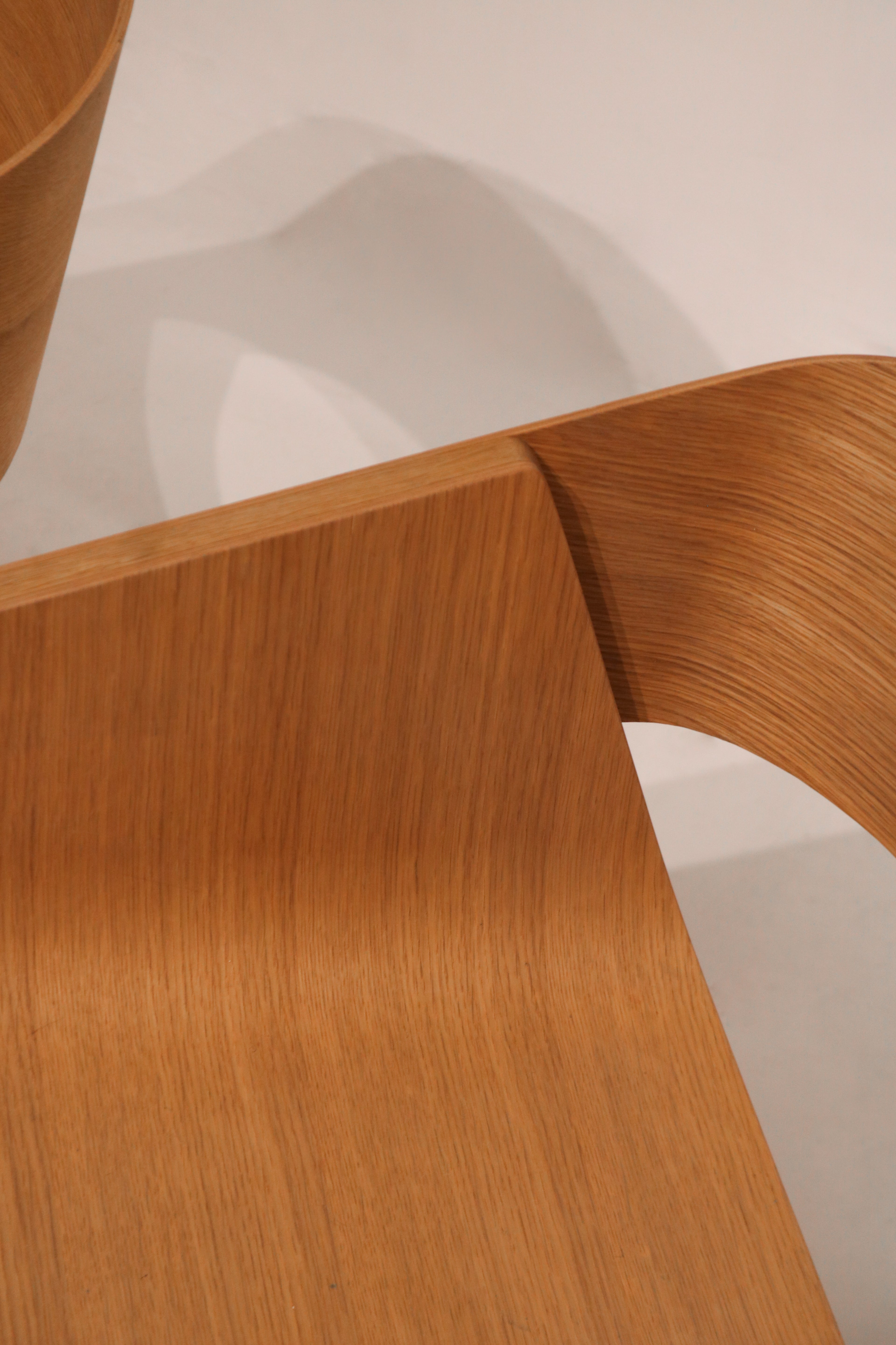 Back view showing solid ash leg attachment and supportive curved backrest