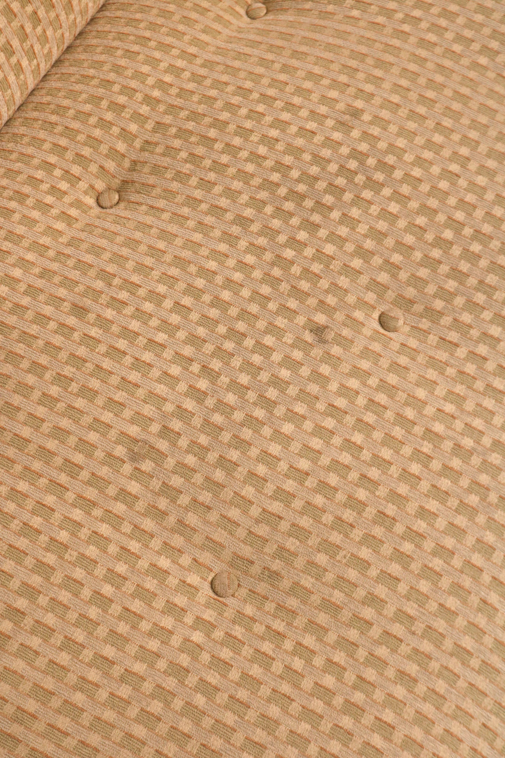 Detail of backrest button tufting demonstrating vintage upholstery style