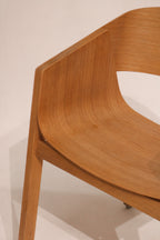 Single Berta dining chair three-quarter angle showing curved backrest design