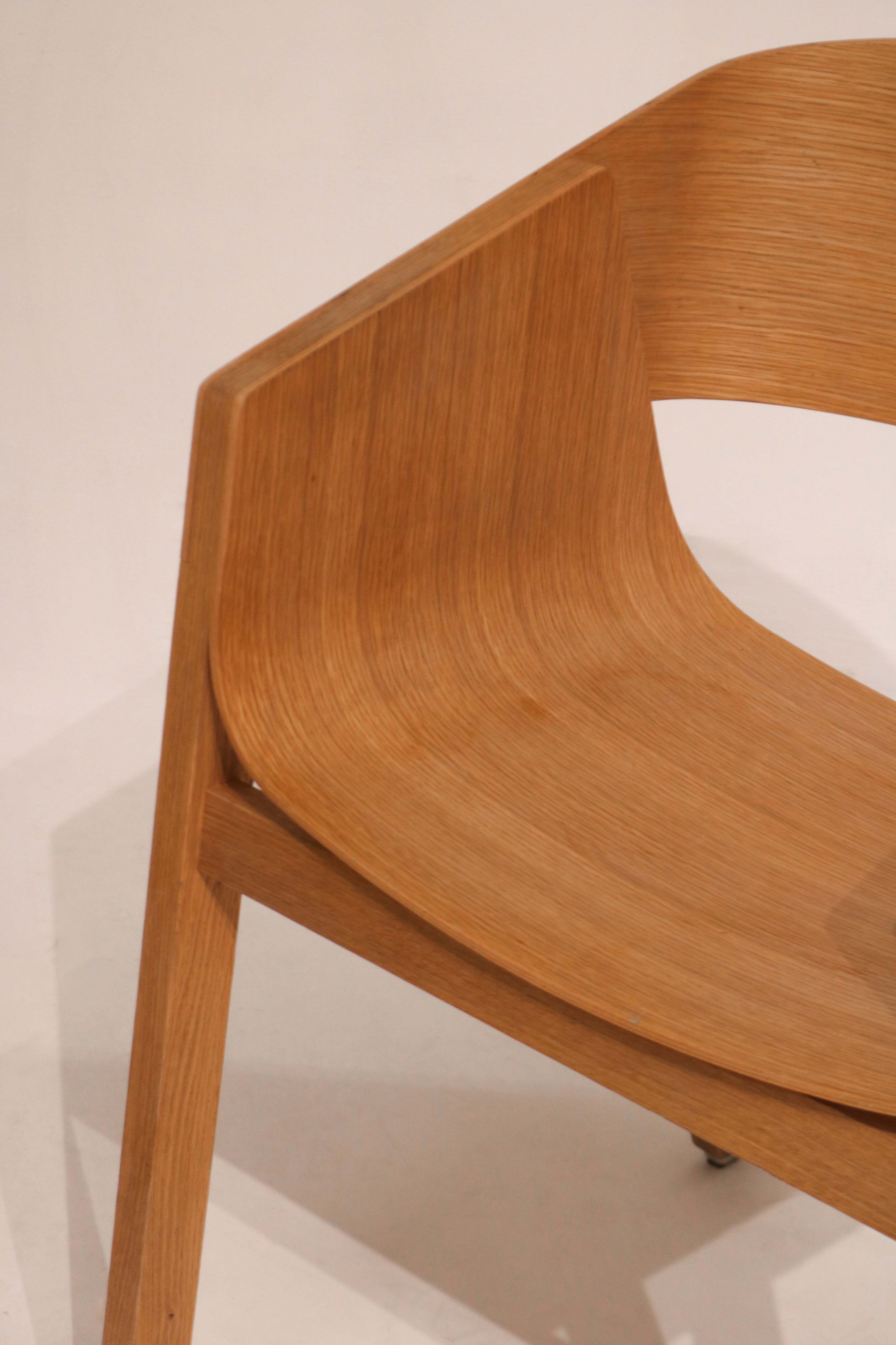 Single Berta dining chair three-quarter angle showing curved backrest design