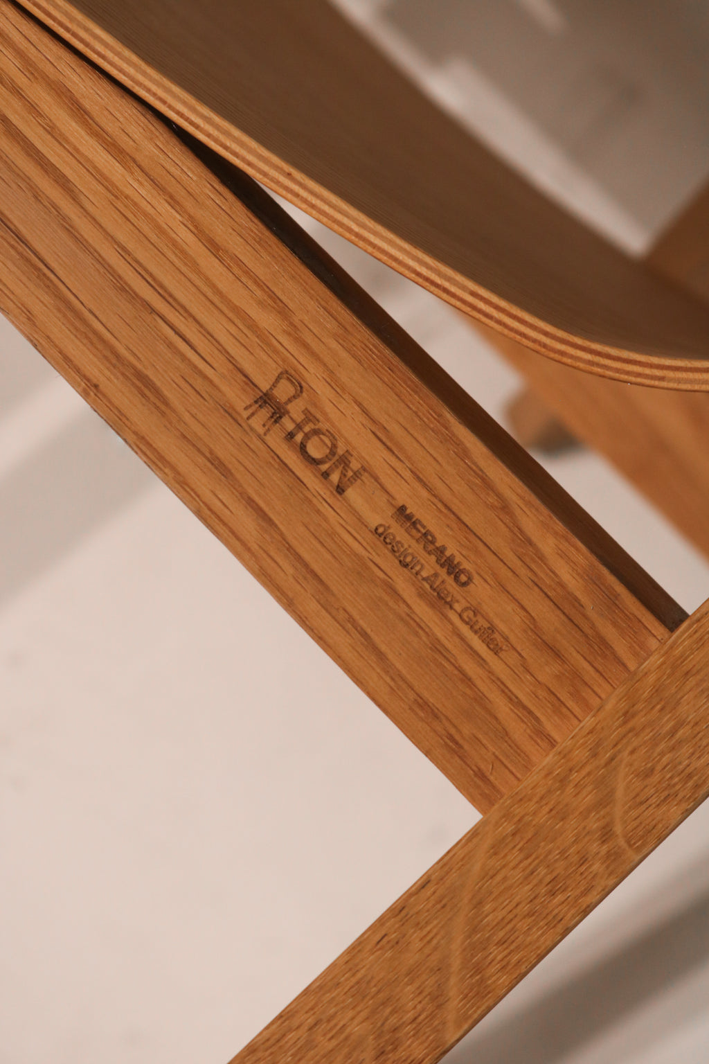 Close-up detail of TON brand stamp and designer mark under seat Alexander Gufler