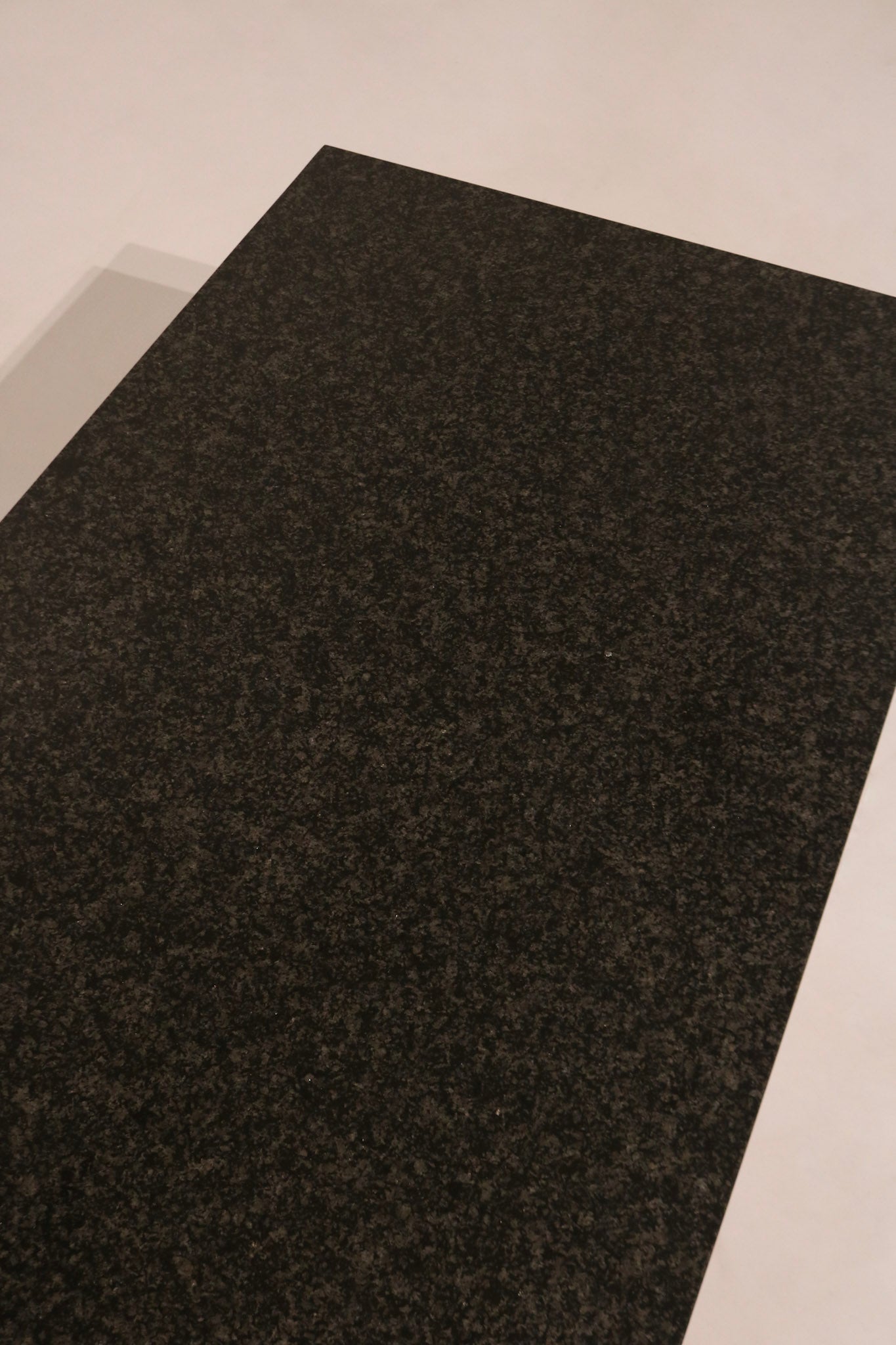 Top view close-up of black stone surface texture and speckled pattern