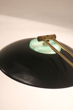 Top view of the black metal shade and brass arm connection