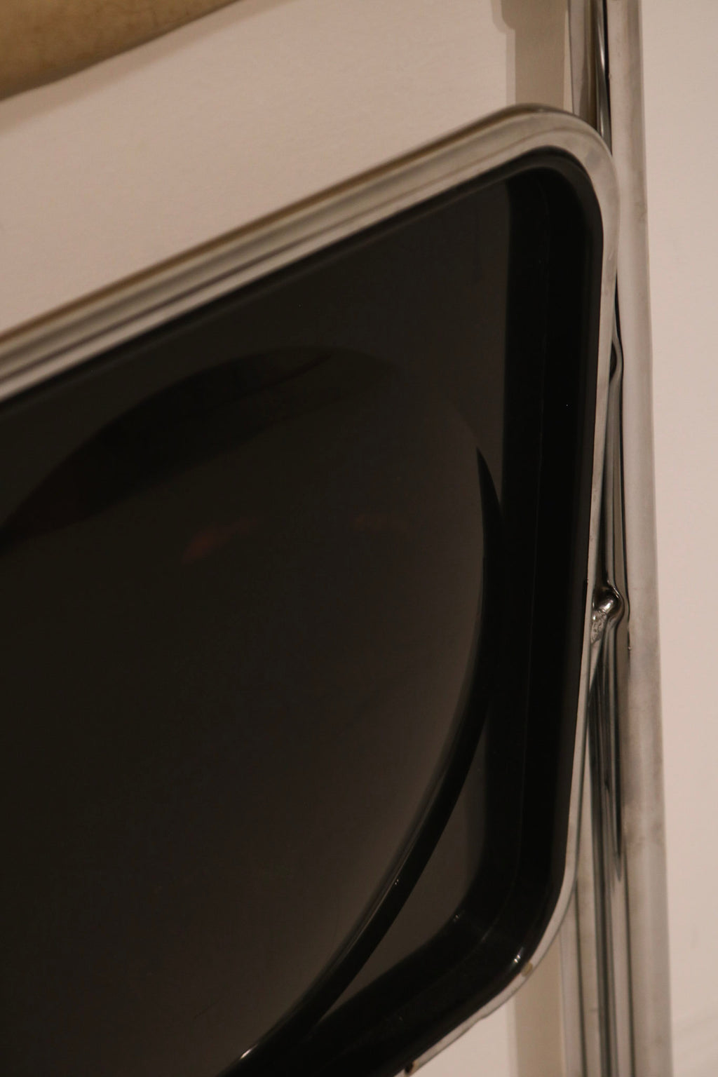 Detail of glossy black plastic back panel contrasting with chrome
