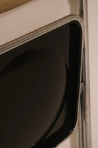 Detail of glossy black plastic back panel contrasting with chrome