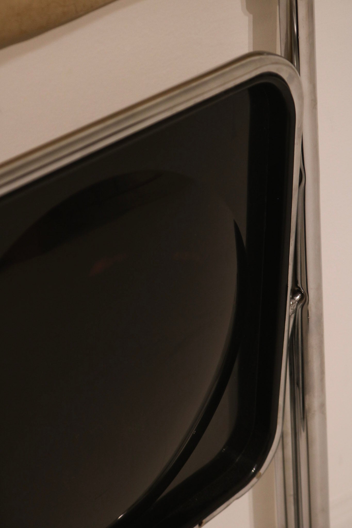 Detail of glossy black plastic back panel contrasting with chrome