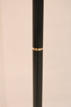 Detail of the black metal pole with decorative brass accent ring