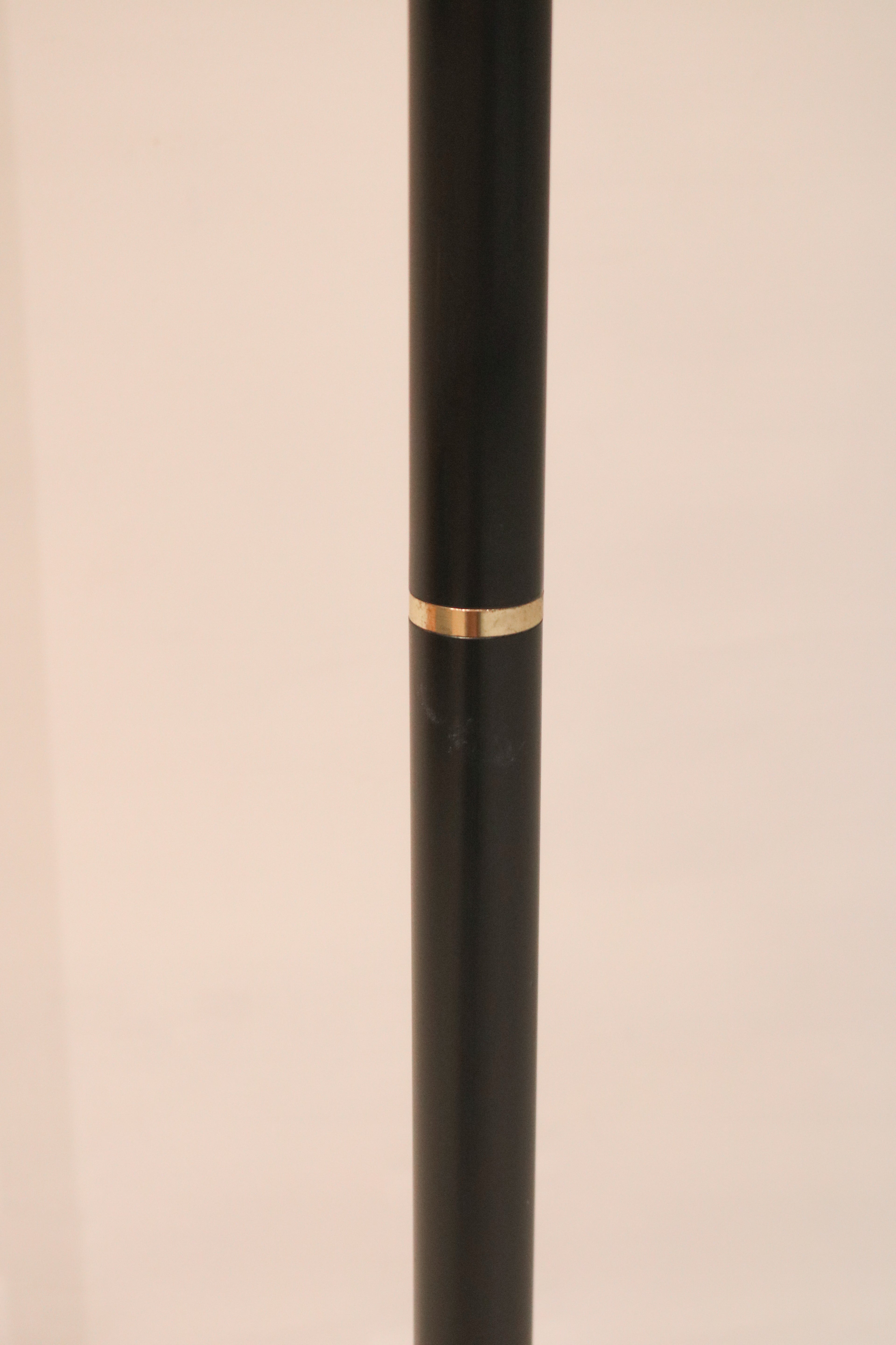 Detail of the black metal pole with decorative brass accent ring