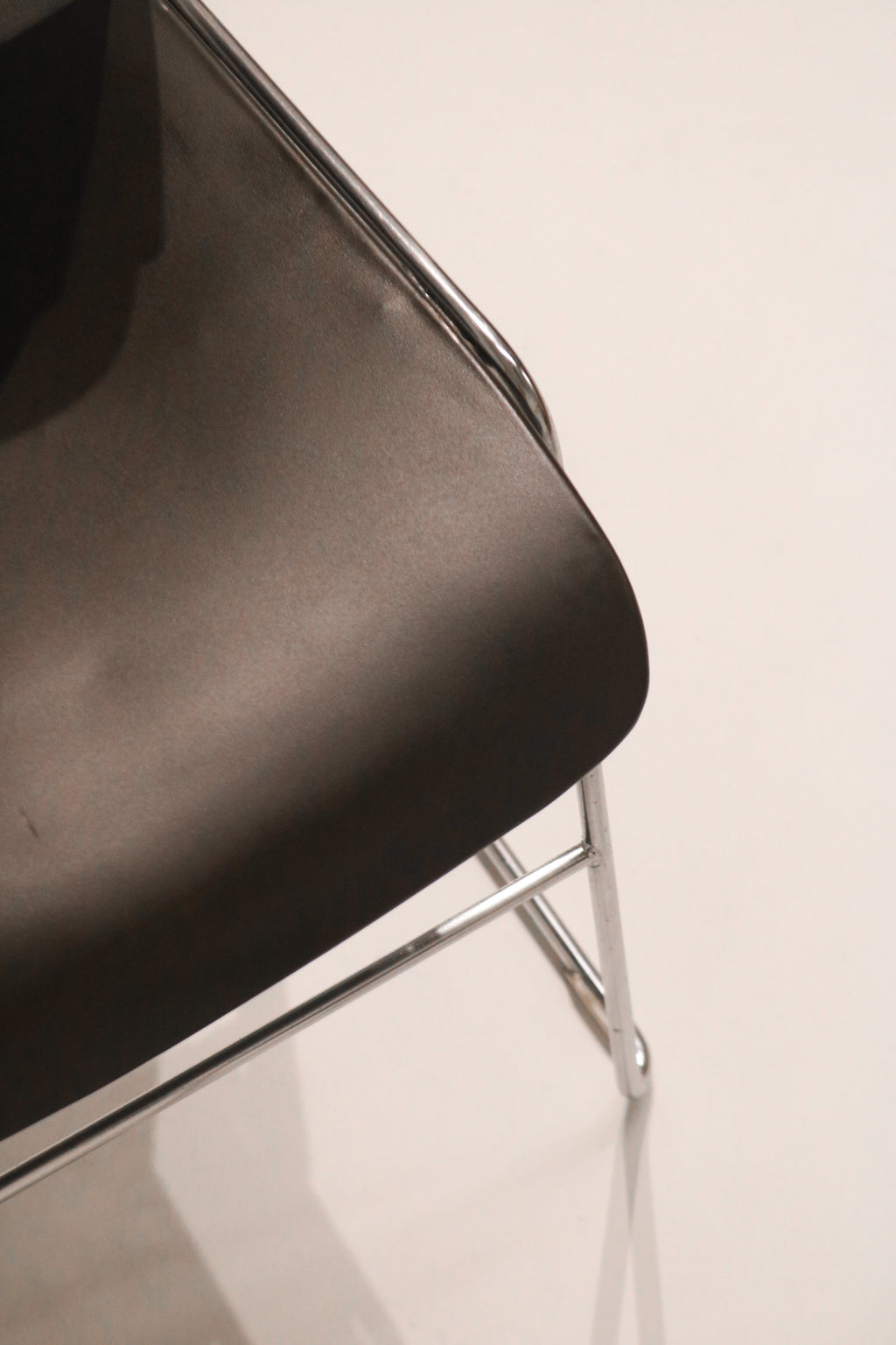 Close-up detail of black seat edge finish and condition showing light wear