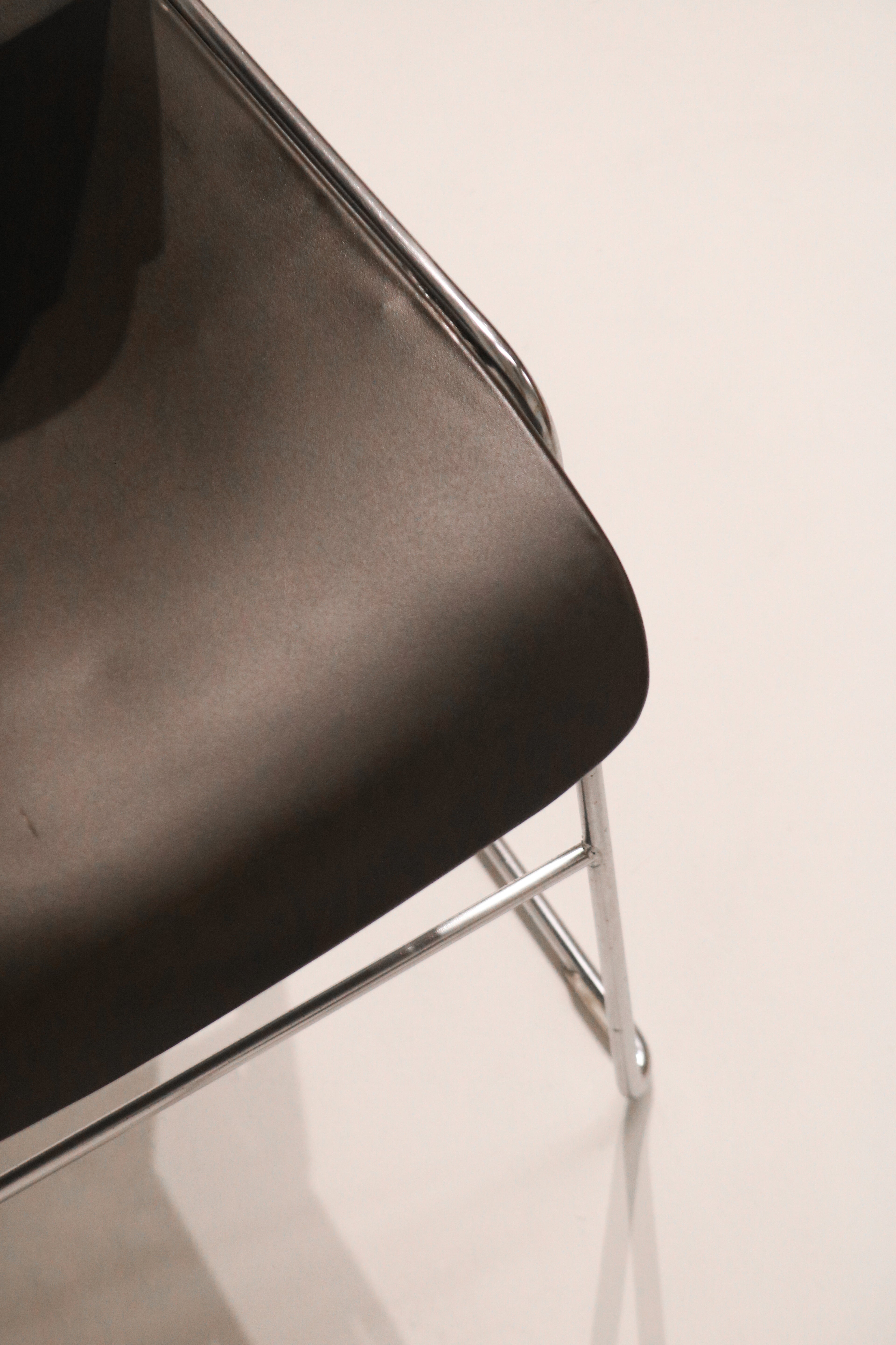 Close-up detail of black seat edge finish and condition showing light wear