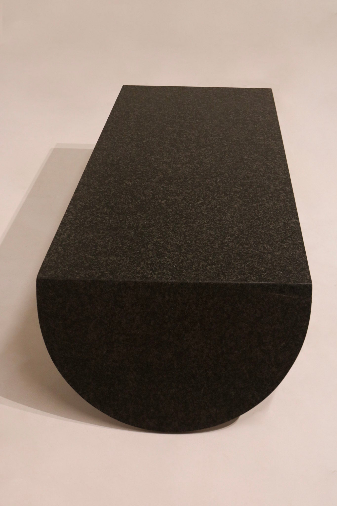 Front view of curved semicircular base end on modern stone coffee table