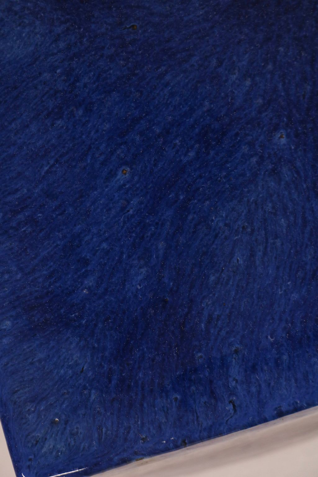 Close-up of blue drip glaze ceramic finish with artistic variations