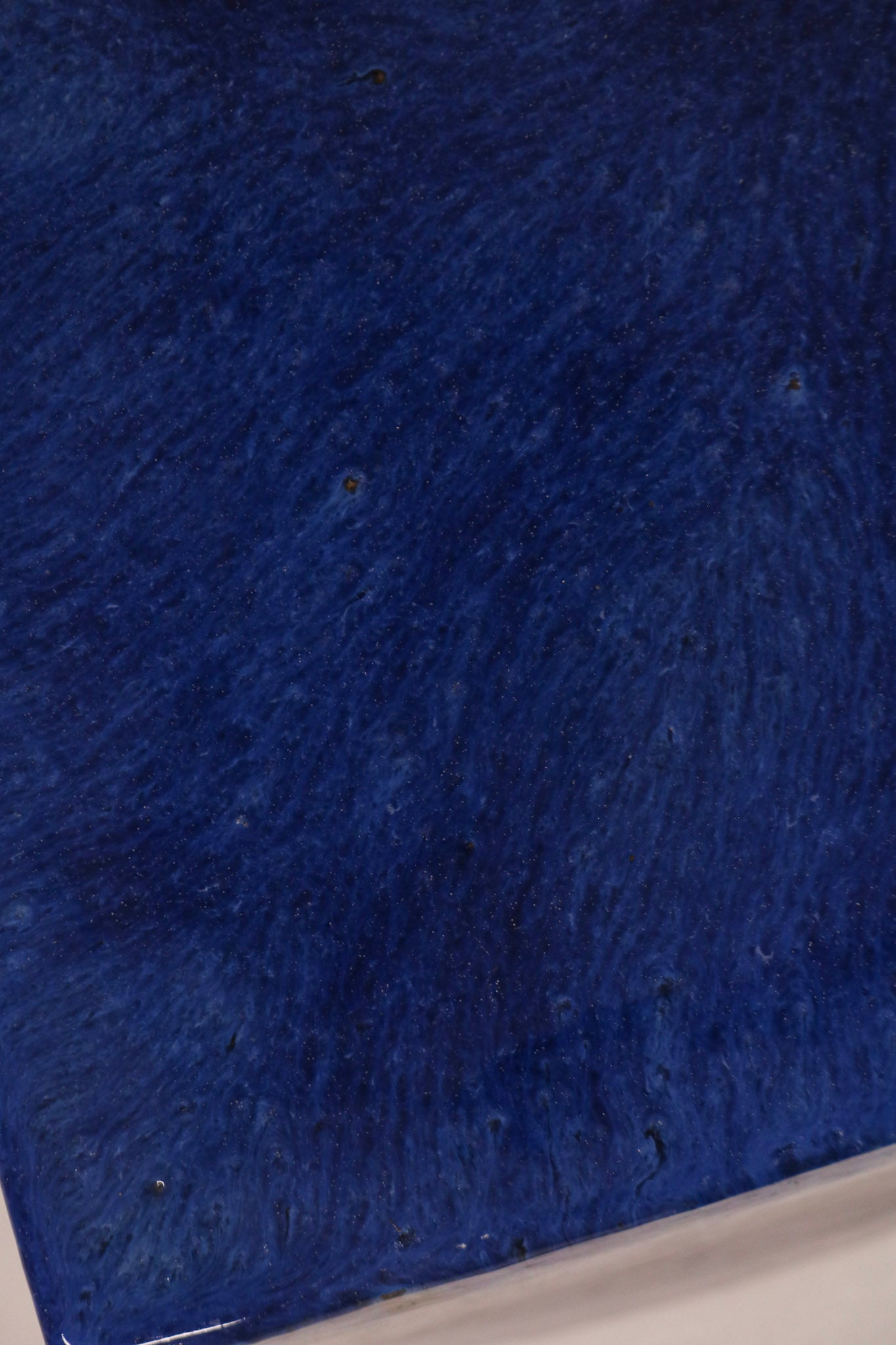Close-up of blue drip glaze ceramic finish with artistic variations