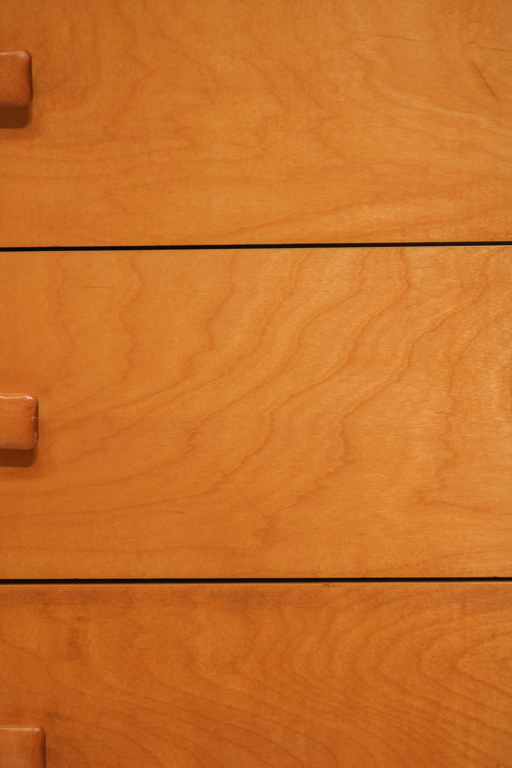 Close-up detail showing small chip damage on the bottom drawer edge