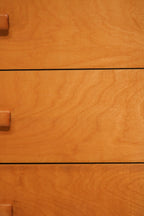 Close-up detail showing small chip damage on the bottom drawer edge