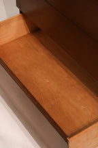 Close-up of the bottom drawer front showing continuous wood pattern