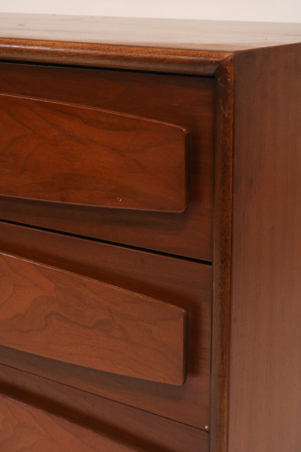 Detail of bottom left drawers highlighting the sculpted design element