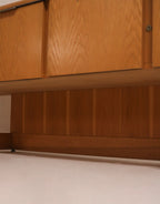 Close-up burl wood drawer fronts showing natural grain pattern and vintage hardware