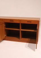 View of cabinet door open showing hinge mechanism and interior finish