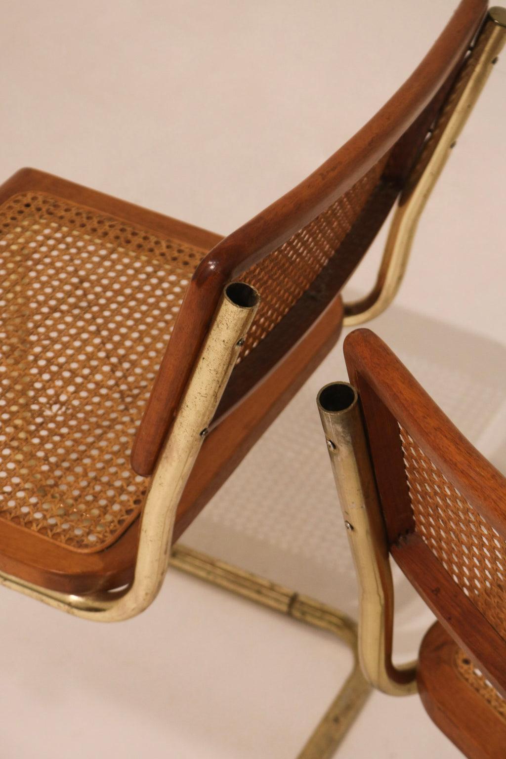 Close-up detail of cane backrest weave and wood frame condition