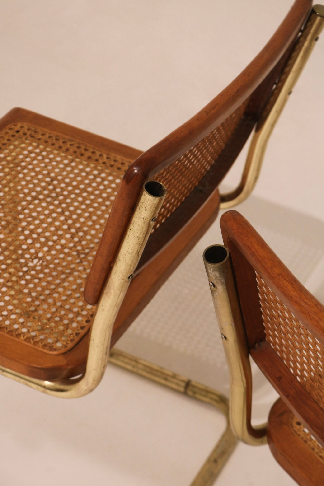 Close-up detail of cane backrest weave and wood frame condition