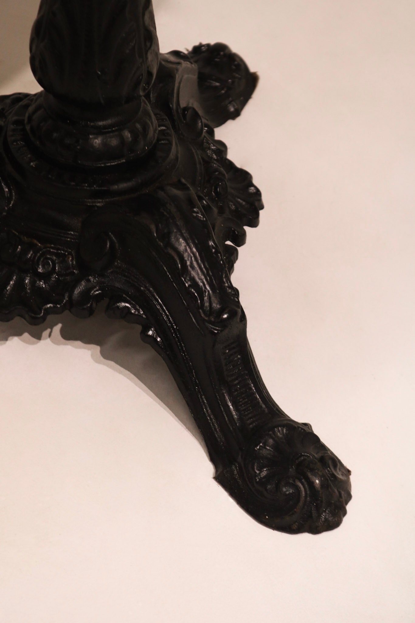 Close-up of ornate cast iron base with claw foot design