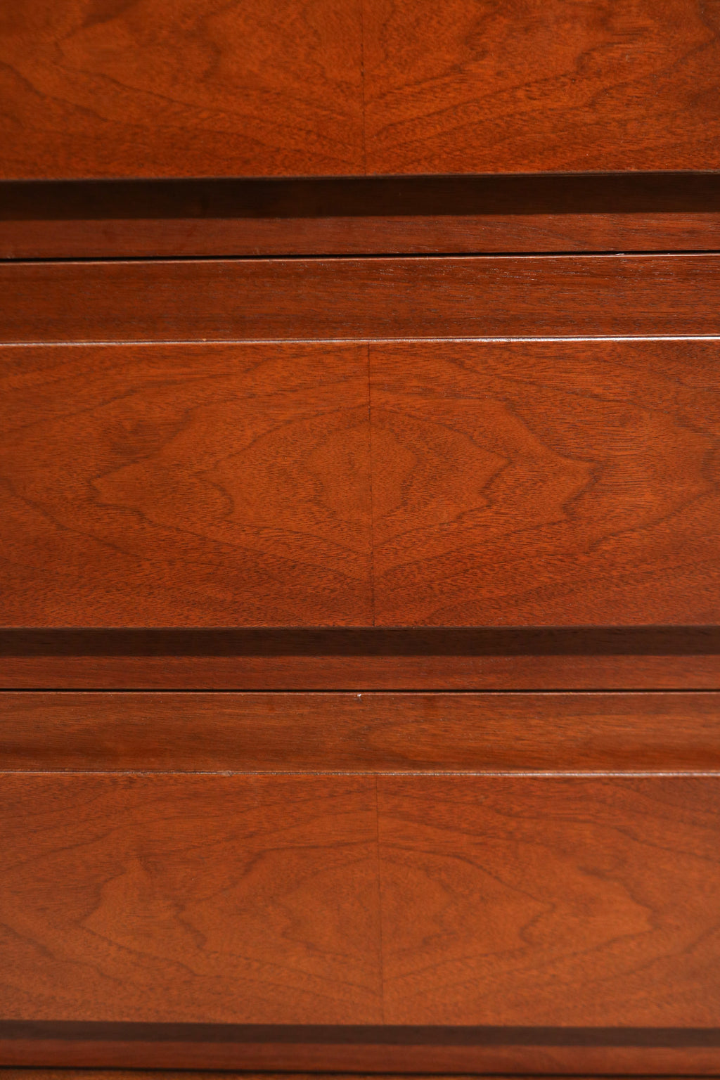 Close-up of center drawer fronts showing matched wood grain pattern