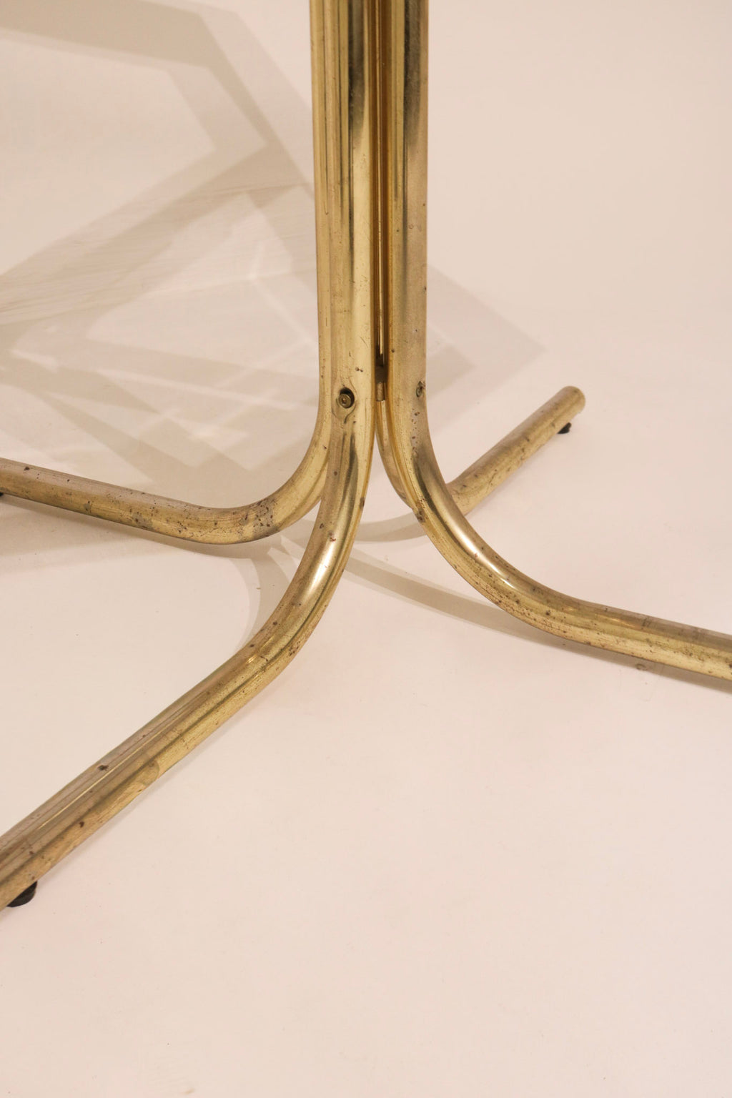 Close-up detail of the plastic floor glides on the tubular metal chair base