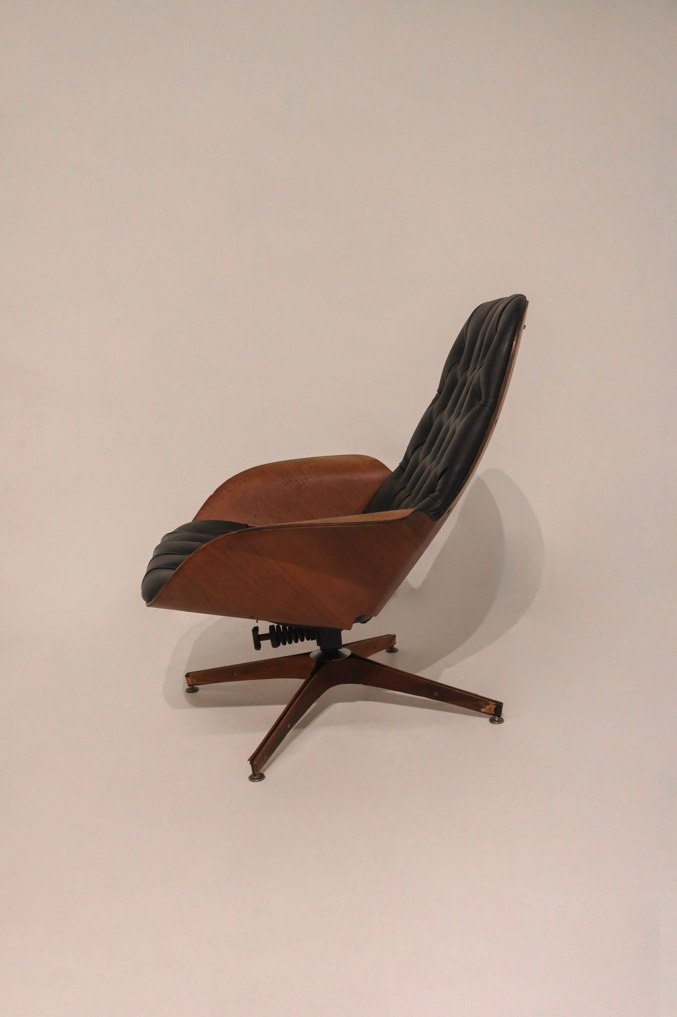 Detail of chair leg glide showing wood wear consistent with age