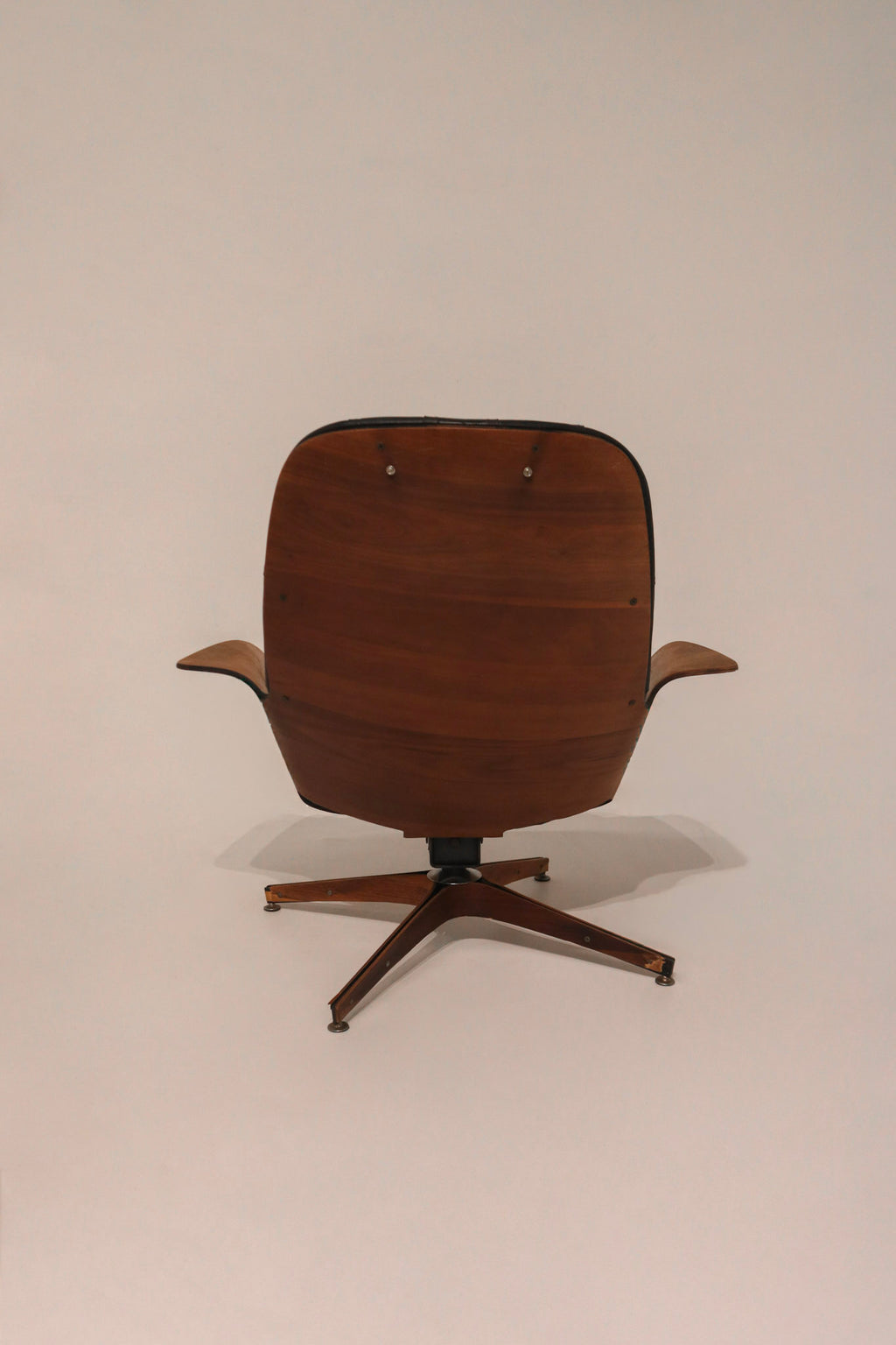 Close-up of chair swivel base mechanism with wood and metal construction