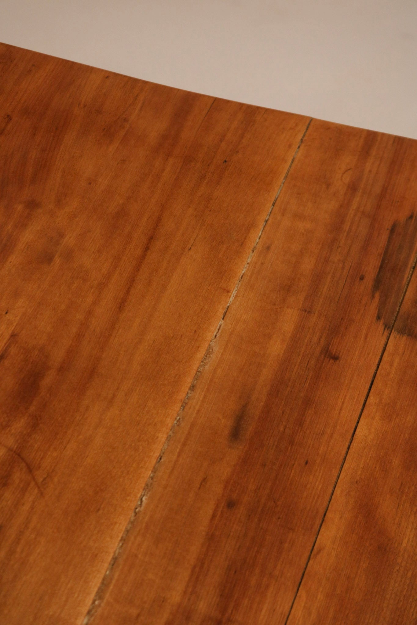 Close-up view of the rich cherry pine wood grain texture