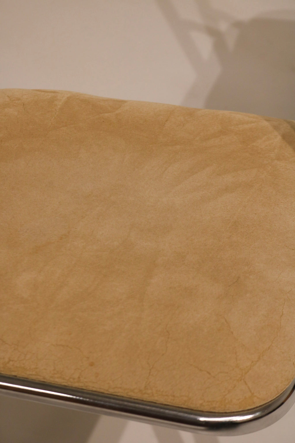 Close-up of chrome leg base with floor protection glides