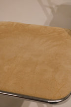 Close-up of chrome leg base with floor protection glides