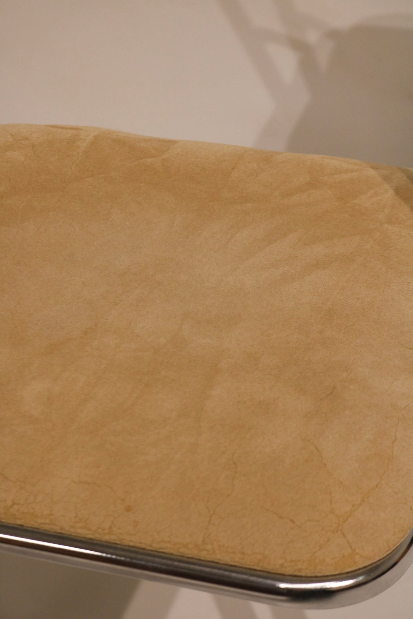 Close-up of chrome leg base with floor protection glides