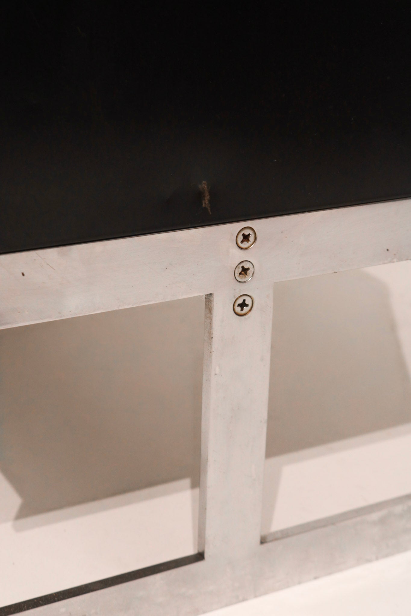 Detail of chrome pull hardware contrasting with black steel panel