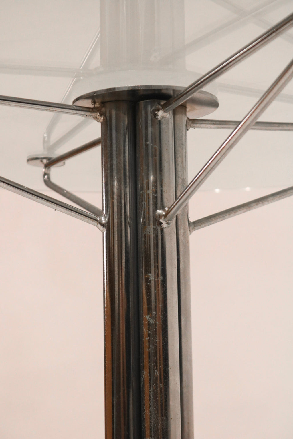 Detail of the central chrome steel column supporting the glass top
