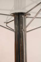 Detail of the central chrome steel column supporting the glass top