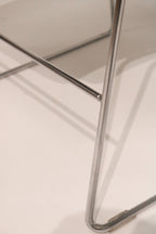 Detail of chrome tubular legs and base construction showing floor glides