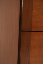 Detail of the distinctive circular metal drawer pulls on the lower drawers